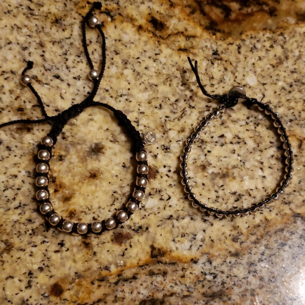 2 black and silver bracelets